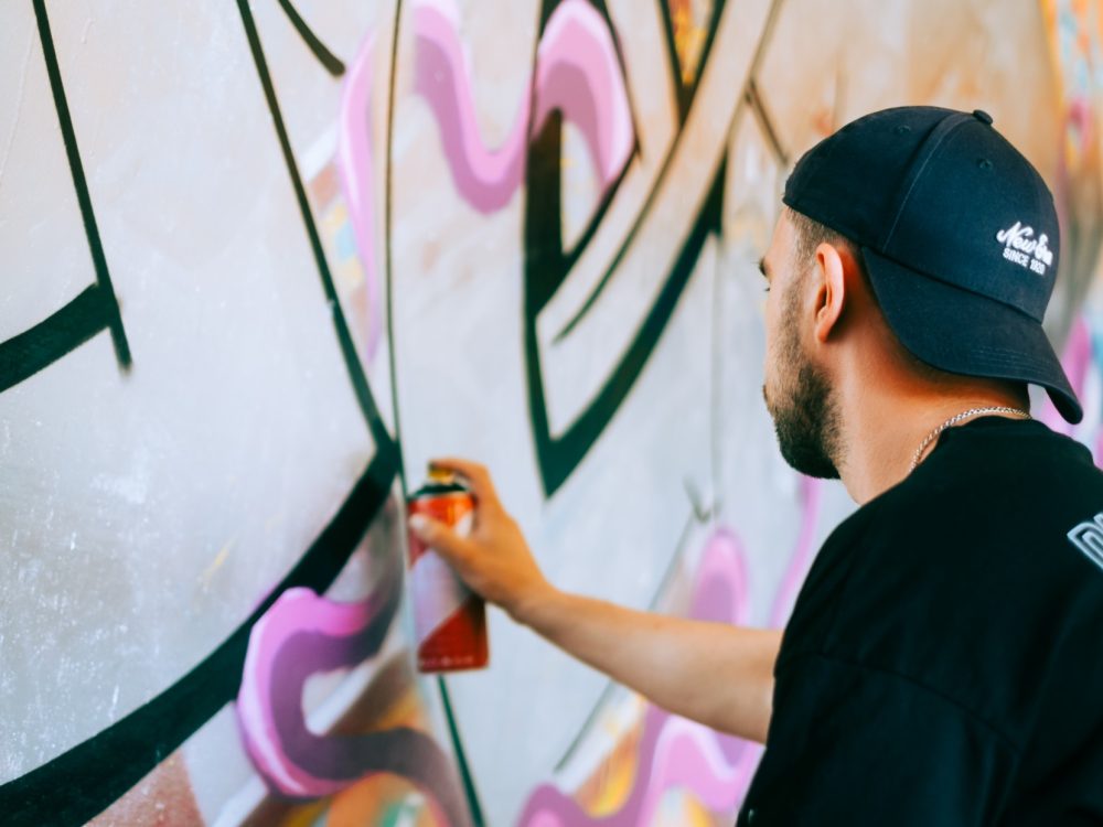 young-caucasian-man-graffiti-artist-drawing-on-a-w-2023-11-27-05-15-31-utc (1)